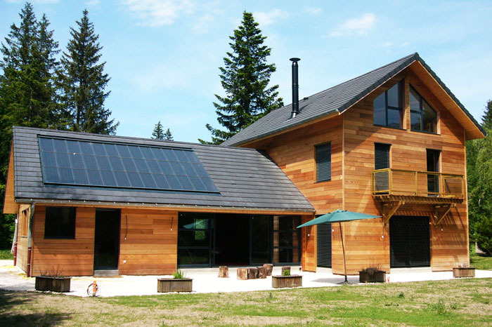 House with slate-covered roof and solar panels