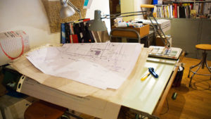Desk of an architect with architectural plans